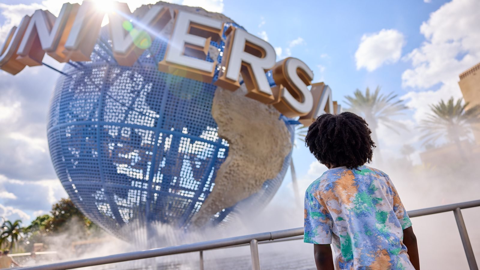 A young guest looking up at the Universal Orlando Resort globe