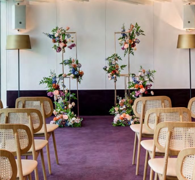 The Scene, an intimate indoor event space with red interiors and floral pillars